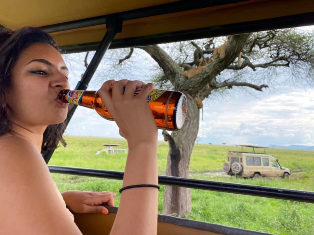 drinking beer with Climb Kilimanjaro and Tanzania Safaris with our guest in Serengeti national park for funny