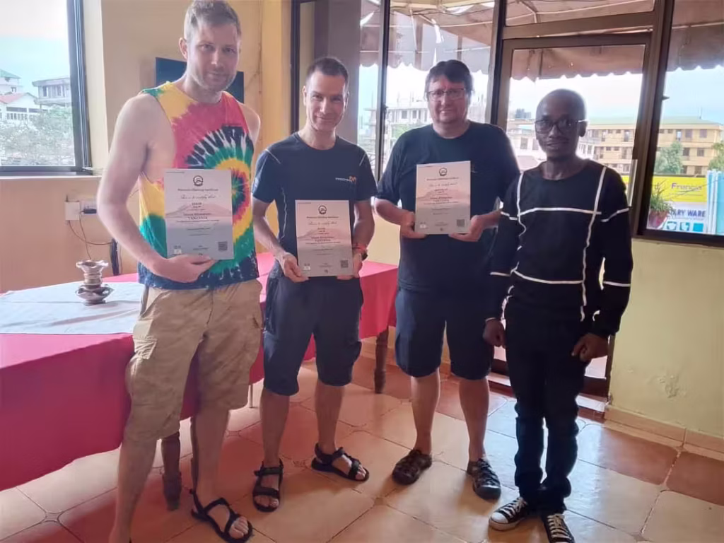 Pavel and his friends with Kilimanjaro summit Certificates by Climb Kilimanjaro and Tanzania Safari